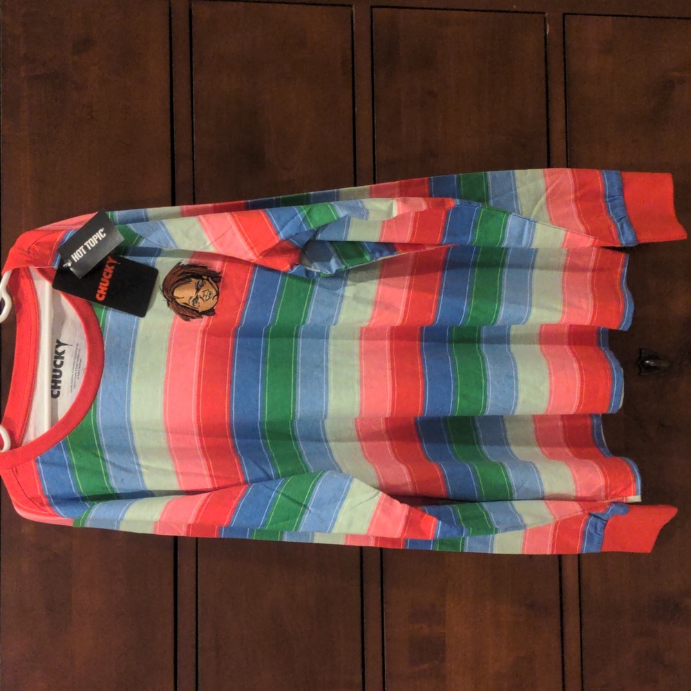 Never worn, multi colored striped shirt with Chucky emblem.